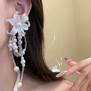 Detailed macro shot showing elegant pearl flower earrings with cascading bead tassels