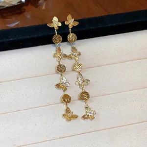 Detail view of 18k gold plated butterfly tassel earrings with sparkling zircon stones