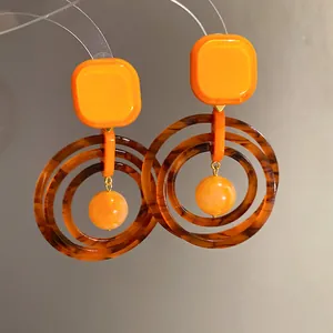Detail of retro Maillard style resin earrings with tortoiseshell layered hoops