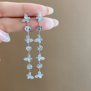 Detailed macro shot of 18k gold plated long butterfly tassel earrings with zircons