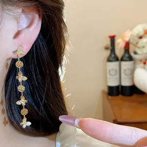 Close-up of elegant 18k gold-plated butterfly tassel drop earrings for women