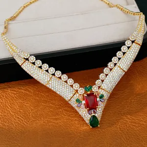 Macro view of 18k gold plated vintage necklace featuring red and green zircon gemstones