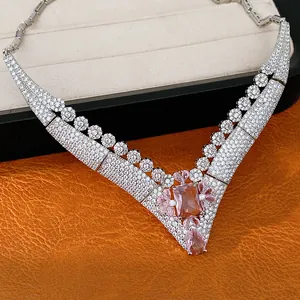 Detailed macro view of retro court style V-shaped necklace with pink zircon gemstones