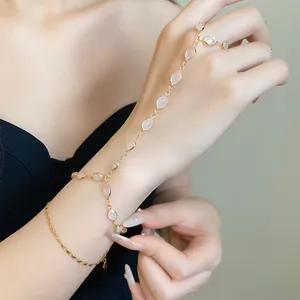 Close-up of vintage style gold hand harness with oval resin stones on hand