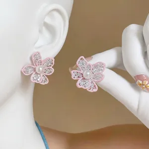 Elegant pink hollow-out flower earrings with pearl center and sparkling crystals