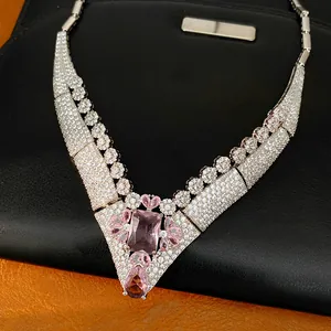 Close-up of vintage 18k gold plated necklace featuring pink gemstones and pave zirconia