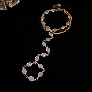 Close-up of elegant vintage gold hand harness featuring white oval resin stones.
