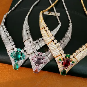 Close-up of 18k gold plated zircon necklaces in green, pink and red vintage palace style