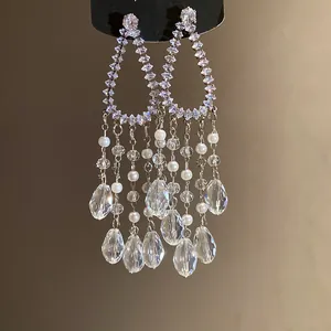 Detailed macro view of elegant zircon tassel earrings with crystal teardrops