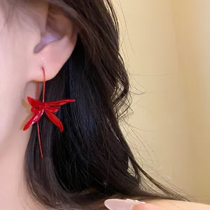 Close-up of elegant red flower drop ear hook earring on model's ear