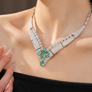 Detailed view of vintage court style necklace with green square emerald and zircons