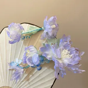 Detail showing translucent periwinkle fabric flower petals and white stamen