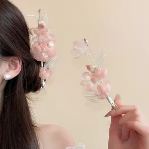 Close-up of elegant pink fabric flower hair clip with white pearls in Hanfu style.
