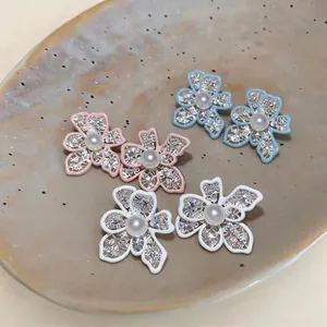 Elegant dripping oil openwork flower earrings with pearl centers in three colors.