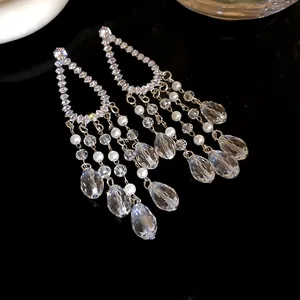 Detailed view of elegant silver needle zircon tassel earrings with crystals and pearls