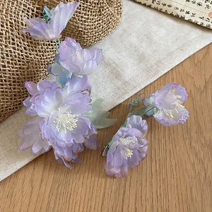 Detailed view of handmade purple fabric flower hair clips in elegant Hanfu style
