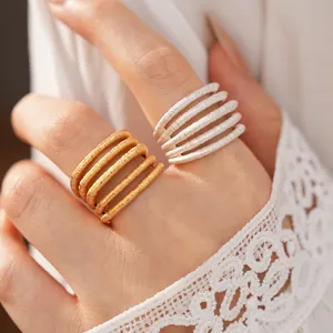 Macro detail of multi-layer coiled texture rings in elegant gold and silver finish