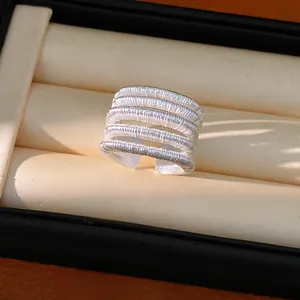 Detailed close-up showing the intricate 5-layer textured silver open ring in a jewelry case