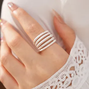Detail shot of an elegant silver multi-layer spiral ring worn with a white lace sleeve