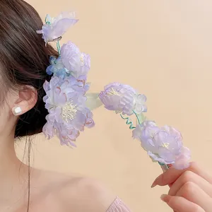 Close-up view of elegant purple fabric flower hair clips featuring delicate pearl details