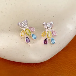 Detailed close-up of exquisite colorful zircon bear stud earrings with silver finish