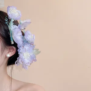 Detailed view of elegant purple fabric flower hair clip worn on side as Hanfu accessory