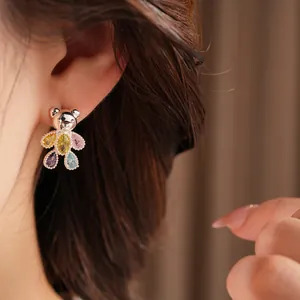 Close-up of cute silver bear stud earrings featuring colorful teardrop zircon stones.