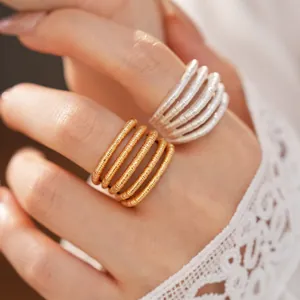 Close-up view of elegant 18k gold plated multi-layer textured open rings on a finger