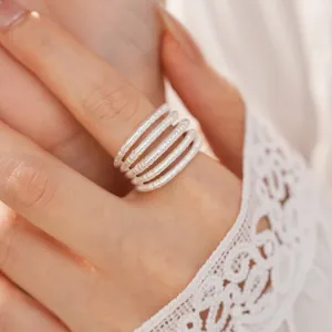 Close-up of a silver multi-layer hollow open ring with brushed metal texture detail.