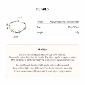 Detailed view of rhinestone fleur-de-lis pearl necklace with size and material specs