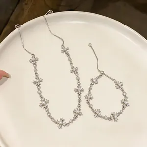 Exquisite detail of silver cross fleur-de-lis necklace and bracelet set with pearls