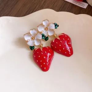 Detailed view of sweet strawberry flower dangle earrings with oil-dripped glaze