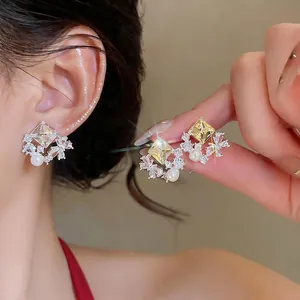 Elegant sterling silver butterfly rhombus zircon stud earrings with pearls shown on model