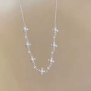 Elegant silver cross star necklace featuring white pearls and tiny diamonds detail.