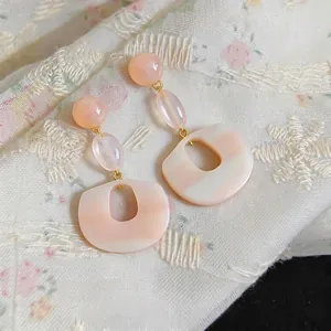 Elegant pink resin oval drop earrings with silver needles for a sweet minimalist look