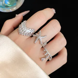 Close-up view of elegant silver starfish open ring set with sparkling zircon stones