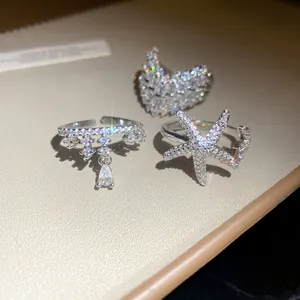 Close-up of sparkling cubic zirconia rings featuring starfish and heart designs