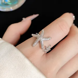 Detailed view of a sparkling silver starfish open ring with micro-pave cubic zirconia.