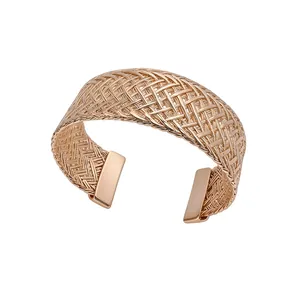Elegant rose gold woven metal cuff bracelet featuring a minimalist open-style design