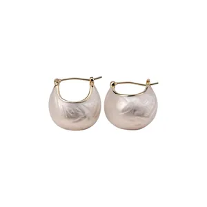 Elegant gold plated enamel bean hoop earrings with minimalist textured cream finish