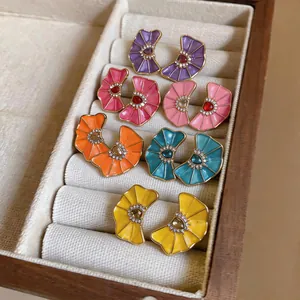 Colorful enamel fan-shaped earrings with rhinestones displayed in a jewelry box
