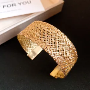 Detailed macro view of high-quality golden vintage metal woven mesh open cuff bracelet