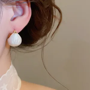 Elegant retro gold plated dripping oil bean earrings featuring a cream white finish