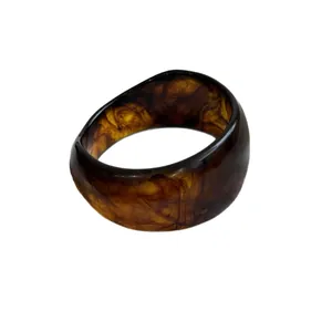 Vintage tortoiseshell resin bangle bracelet, elegant amber-patterned fashion accessory.