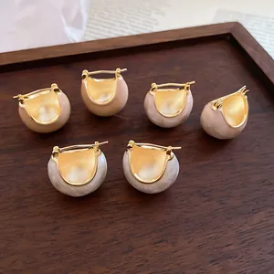 Detailed view of gold plated enamel bean earrings in a retro Korean fashion style
