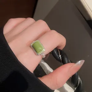 Detailaufnahme eines Vintage-Rings mit grünem Katzenauge und verstellbarem Band