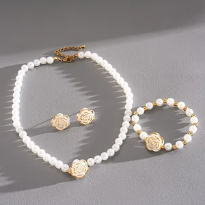 Elegant pearl jewelry set featuring white camellia flowers with golden accents
