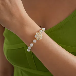 Elegant close-up of a vintage white camellia pearl bracelet with gold edges on wrist