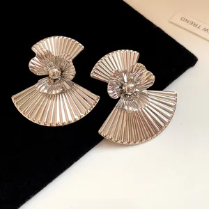 Detailed view of vintage silver pleated metal earrings in a fan-shaped flower design