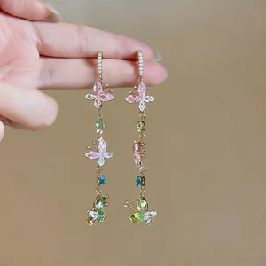 Detailed view of colorful butterfly zircon tassel earrings with elegant gold-tone hooks